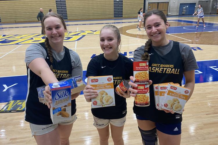 Basketball players holding food items.