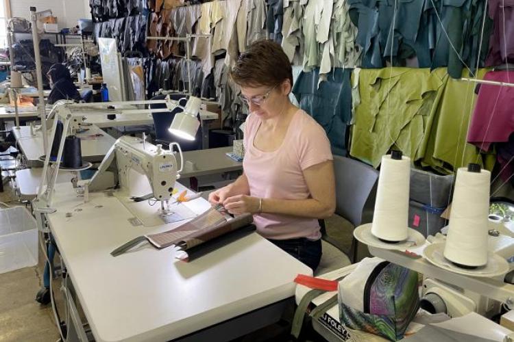 People working on industrial sewing machines.