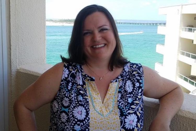 Jennifer Archambault stands on a balcony.