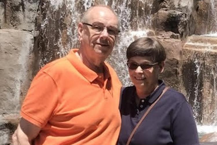 Jerry and Jan Benham posing near a waterfall.