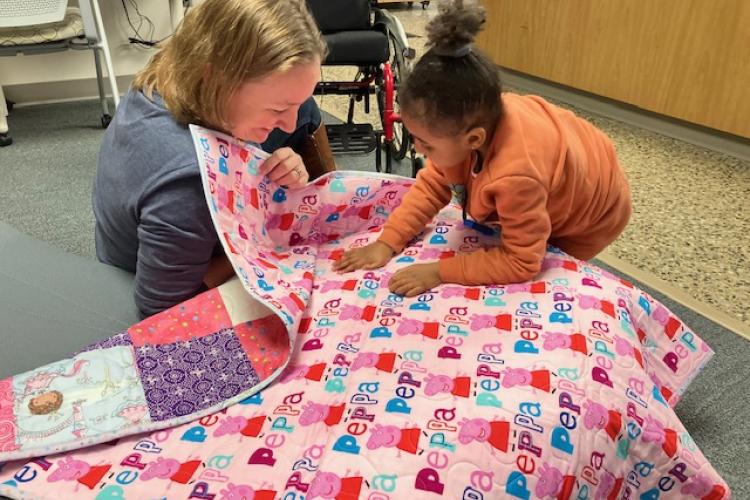 Julie Sizemore showing Island her new quilt. 