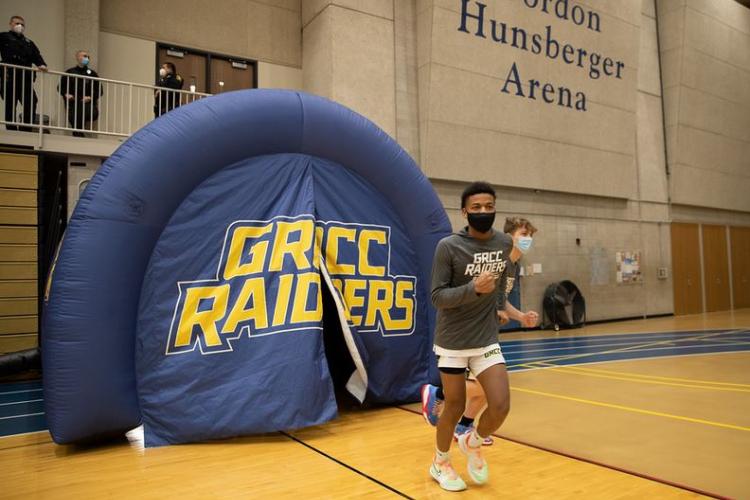 GRCC basketball players running through an inflatable tunnel.