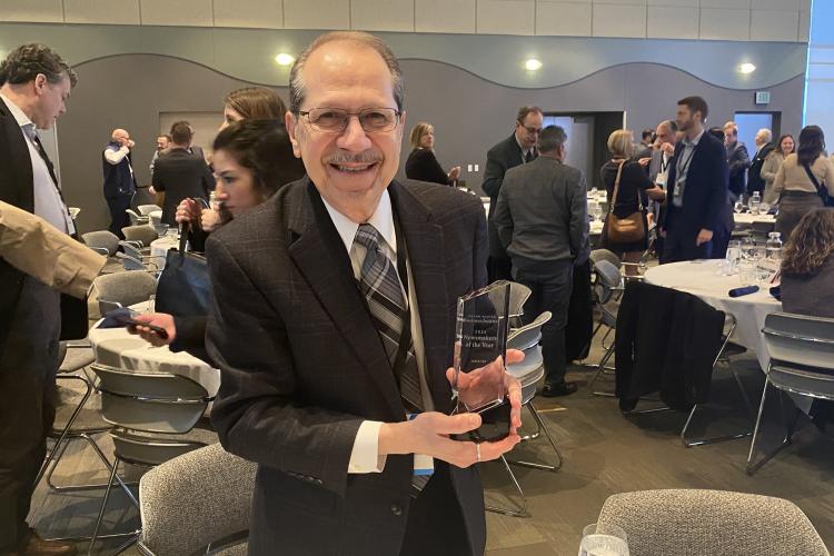 President Olivarez holding his trophy.