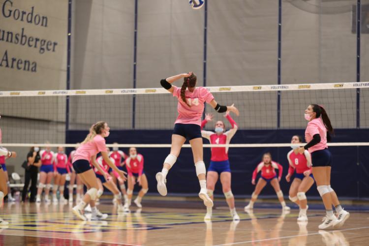 GRCC players in action, wearing pink jerseys.