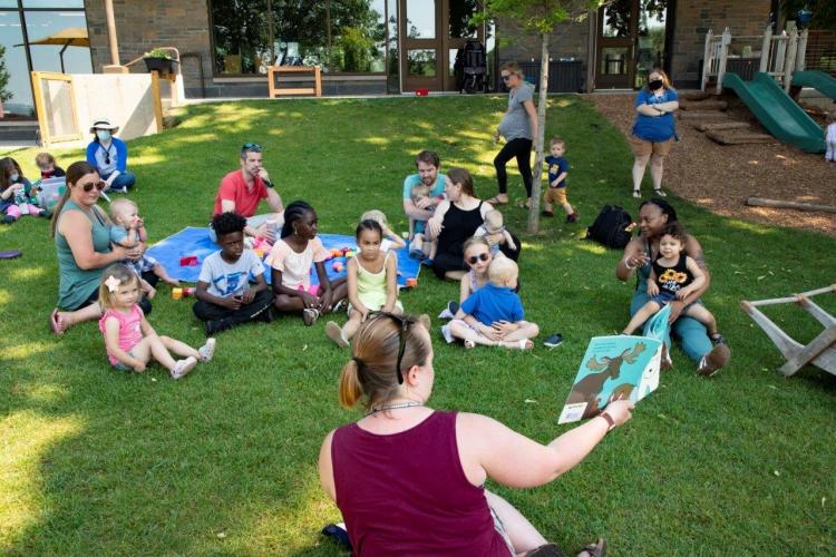 Students listening to a story during a Play and Learn session.