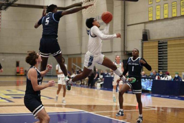 Ryel Daye leaping under the basket.