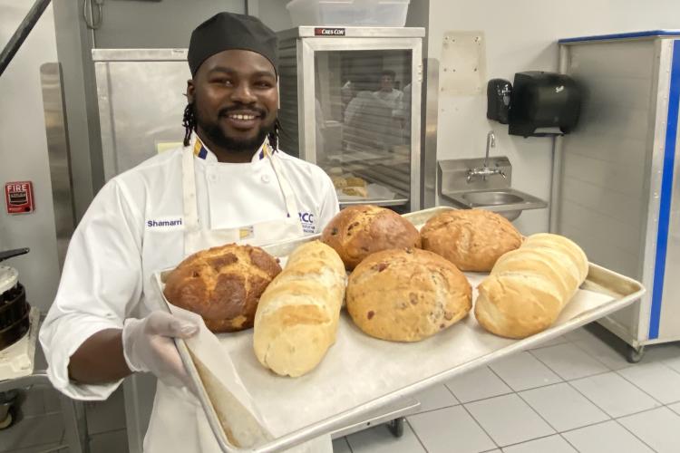 Shamarri Key showing different types of bread baked in his class.