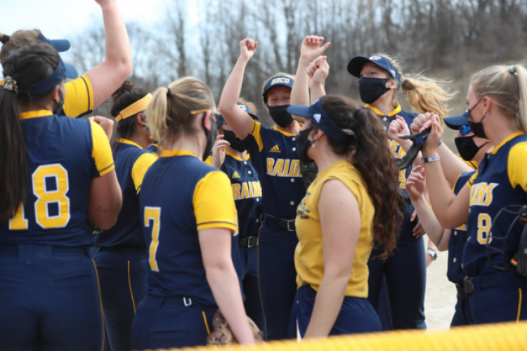 Softball team celebrating.