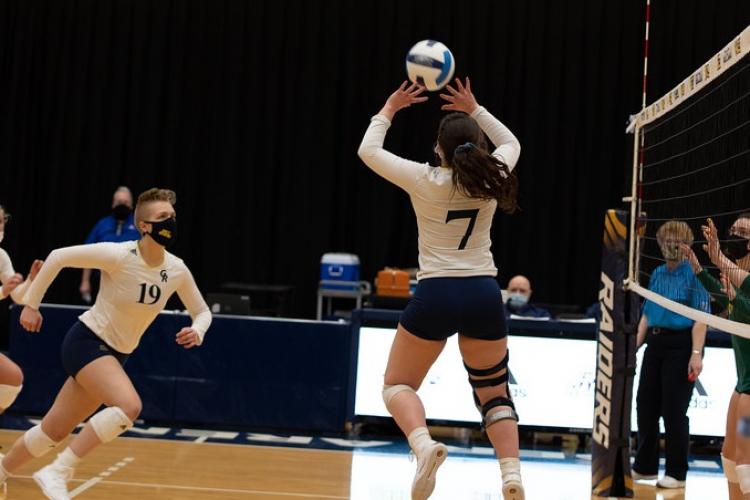 A GRCC volleyball player prepares to set up another for a spike.