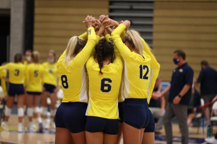 Volleyball players coming together to show support for each other.