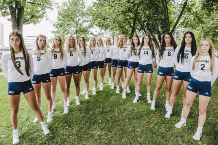 Volleyball team posing for a team photo.