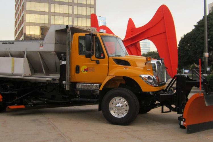 A Grand Rapids municipal dump truck is parked by the Calder statue.