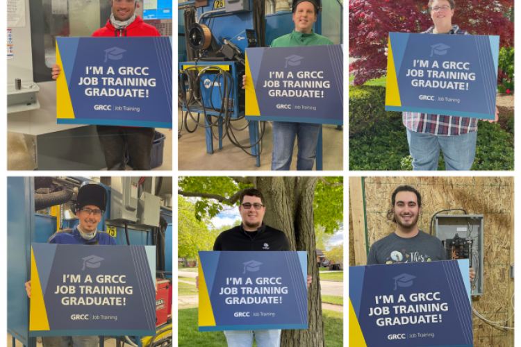 Recent Job Training grads posing with signs.