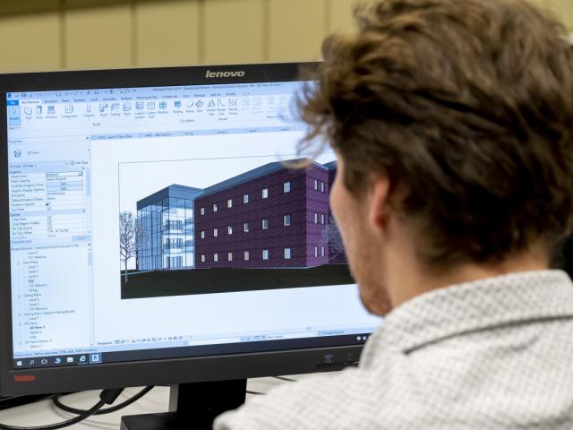 Student uses CAD program to design buildings.
