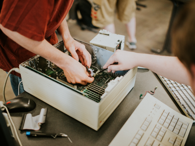 Students working on a disassembled computer.
